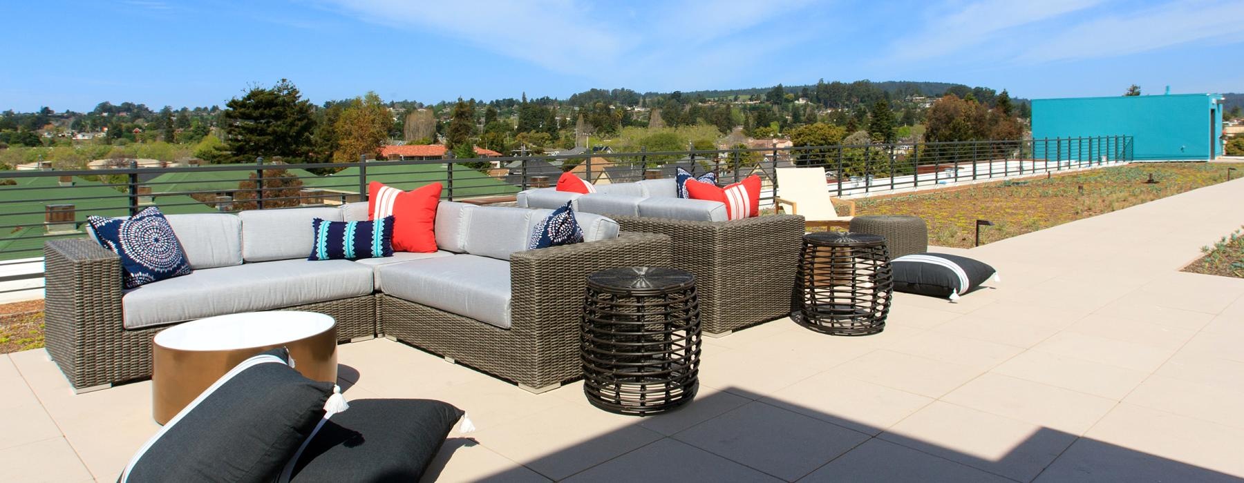 a patio with a couch and chairs